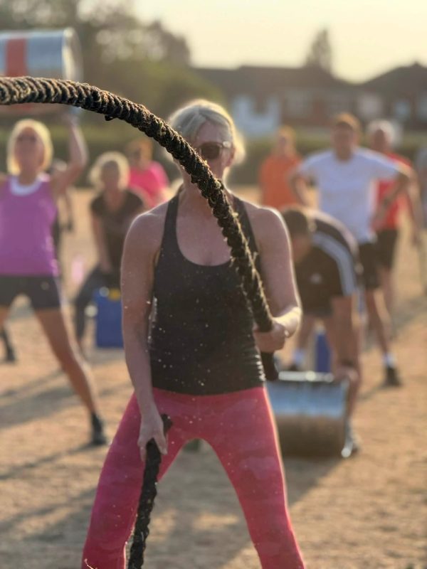 Bootcamp UK outdoor fitness class doing circuit training in the park