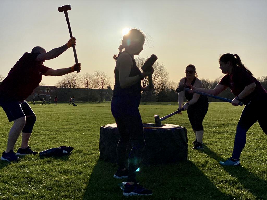 Bootcamp UK Winchester - Group outdoor fitness classes doing sledge hammer exercises